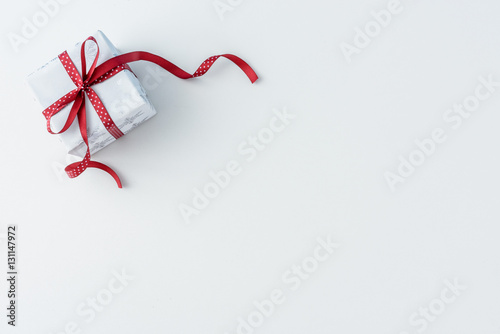 Christmas present with red dotted ribbon holiday background