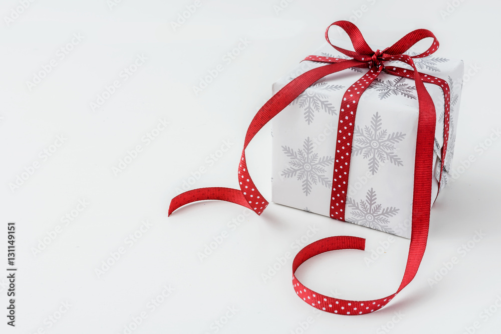 Winter holiday present with red dotted ribbon Winter holiday present with red dotted ribbon
