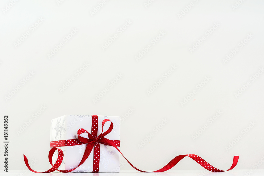 Winter holiday present with red dotted ribbon Winter holiday present with red dotted ribbon