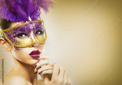 Fototapeta Naklejka Na Ścianę i Meble -  paarty woman swearing golden mask on light backgound