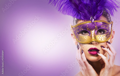 Fototapeta Naklejka Na Ścianę i Meble -  paarty woman swearing golden mask on light backgound