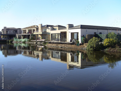 House reflected in water at Century Cirty, Cape Town, South Africa © Anthony