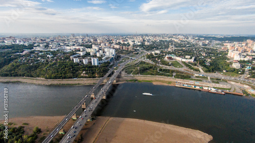 Autumn in city. Panoramic aerial view at road, forest, river.