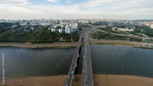 Autumn in city. Panoramic aerial view at road, forest, river.