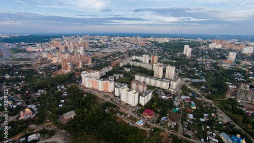 Autumn in city. Panoramic aerial view at road, forest, river.