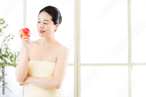 beautiful skin asian woman towel wrap holding fresh apple