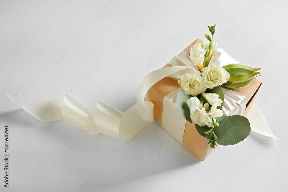 Fototapeta premium Handcrafted gift box with flowers on white background