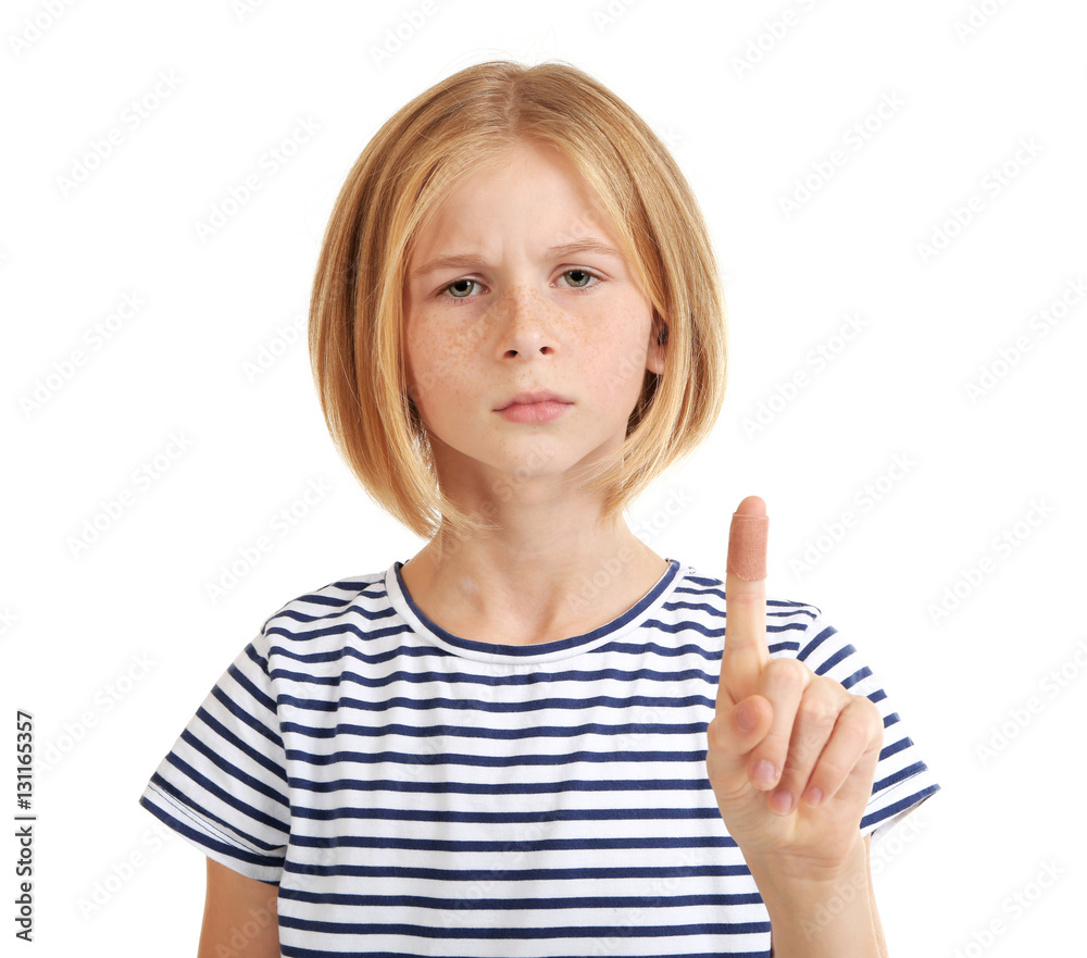 Girl showing finger with sticking-plaster, isolated on white Girl showing finger with sticking-plaster, isolated on white