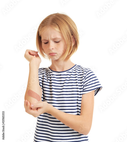 Girl showing hand with sticking-plaster, isolated on white