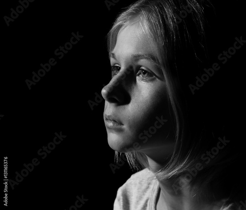 Black-and-white photo of sad little girl