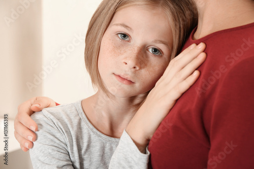 Woman becalming little sad ...
