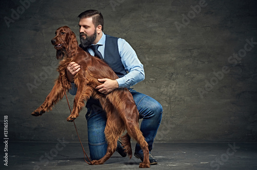 Mddle age male and  Irish red setter. photo