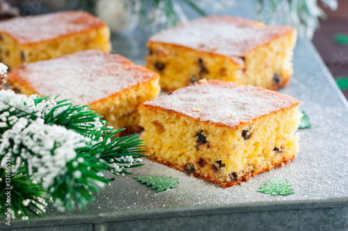 Orange cake with chocolate chips in the Christmas decor, horizontal