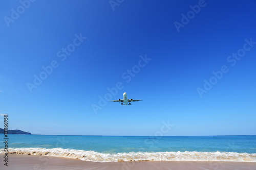 PHUKET, THAILAND - NOVEMBER 17 : The airplane landing at Phuket airport over the Mai Khao Beach on November17, 2016 in Phuket, Thailand.