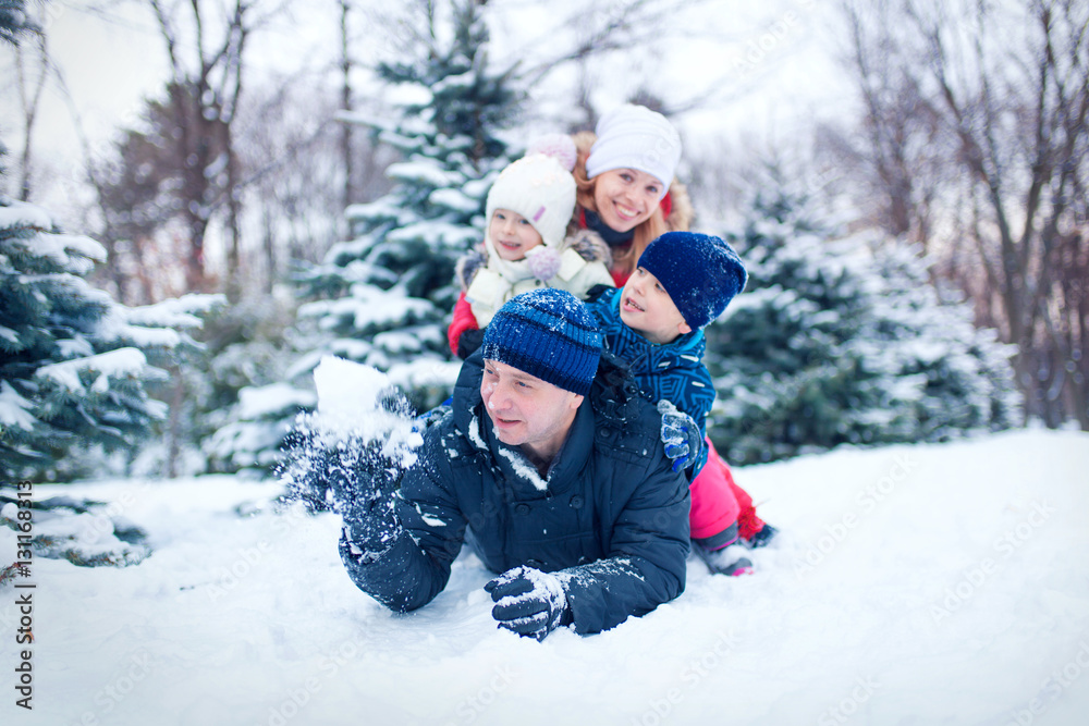 Attractive family having fun in a winter park Attractive family having fun in a winter park