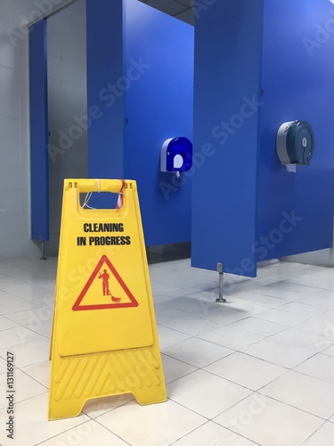 Caution wet floor or cleaning in progress. A yellow sign warning area is being cleaned.