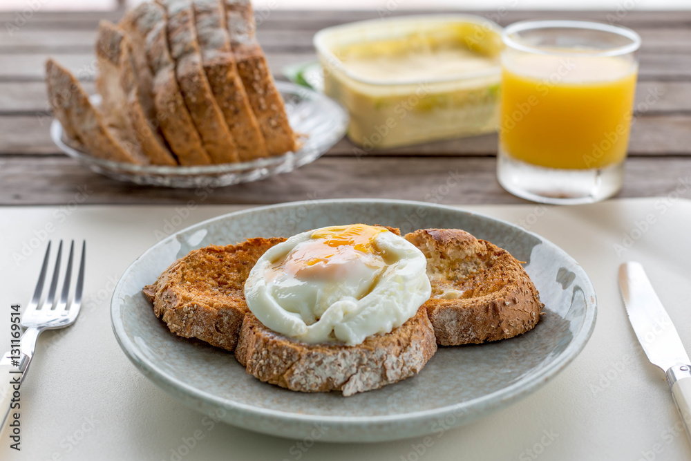 Breakfast fried eggs on crusty toasted bread with orange juice a Breakfast fried eggs on crusty toasted bread with orange juice a