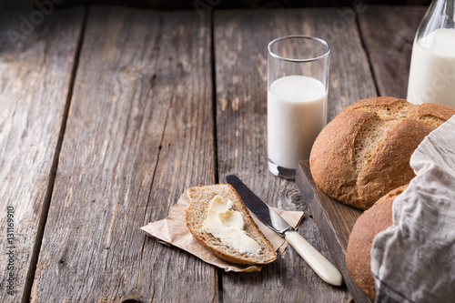 Bild auf Leinwand Rustic breakfast with wholegrain bread, milk and butter