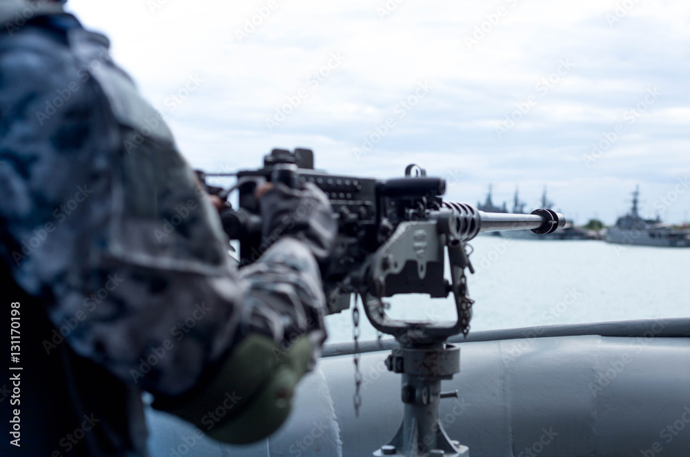 Selected focus Navy soldier hand on machine gun on