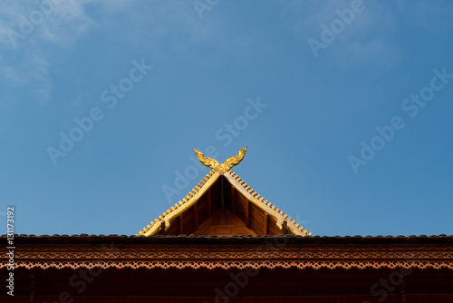 Thailand traditional roof on the blue sky background