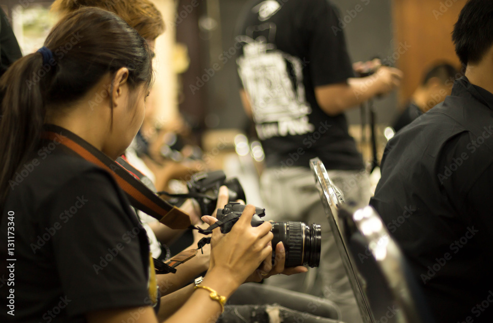 Woman hand holding camera in workshop room Woman hand holding camera in workshop room