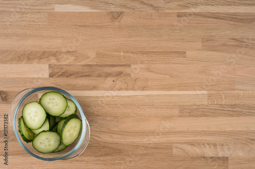 cucumber slices on wooden background.