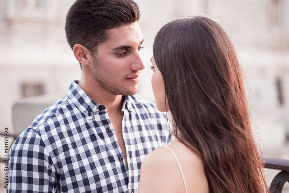 Young and beautiful couple kissing at sunset Young and beautiful couple kissing at sunset