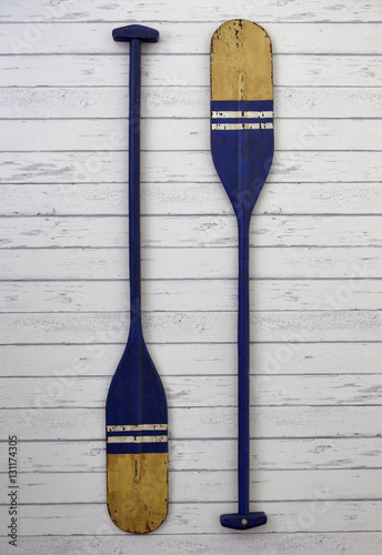 Blue oar wood hang on white wood background photo