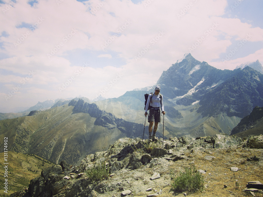 Fototapeta premium Man tourist walking the mountains with a backpack.