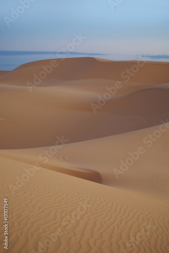 Desert landscape on sunrise in Vietnam. Soft sunlight over ridges and shapes of sand dunes