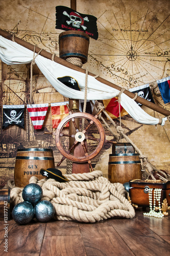 Pirates ship deck with steering wheel and flag photo