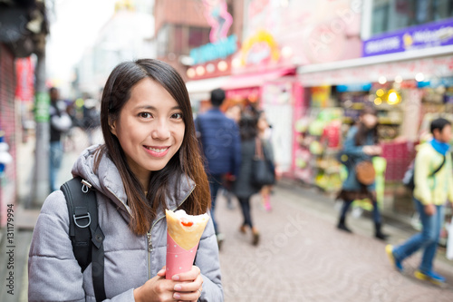 Young woman enjoy her crepe cake at outdoor
