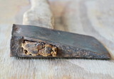 old iron ax with wooden handle on plank