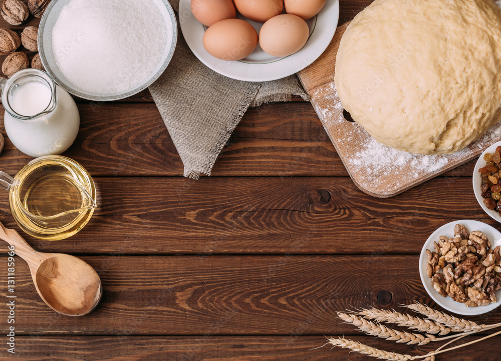 Top view Baking ingredients for homemade pastry on dark rustic wood background Top view Baking ingredients for homemade pastry on dark rustic wood background
