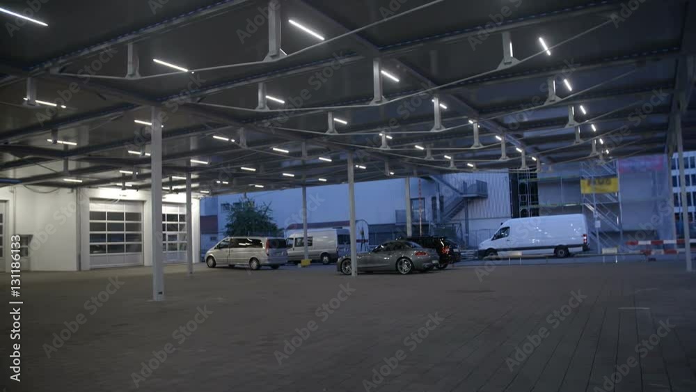 We can see a sun protection roof over a parking lot. There are only a few cars parked underneath. Wide-angle shot.
We can see a sun protection roof over a parking lot. There are only a few cars parked underneath. Wide-angle shot.