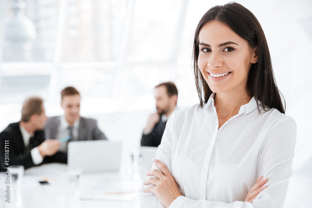 Happy Business woman with colleagues on background Happy Business woman with colleagues on background