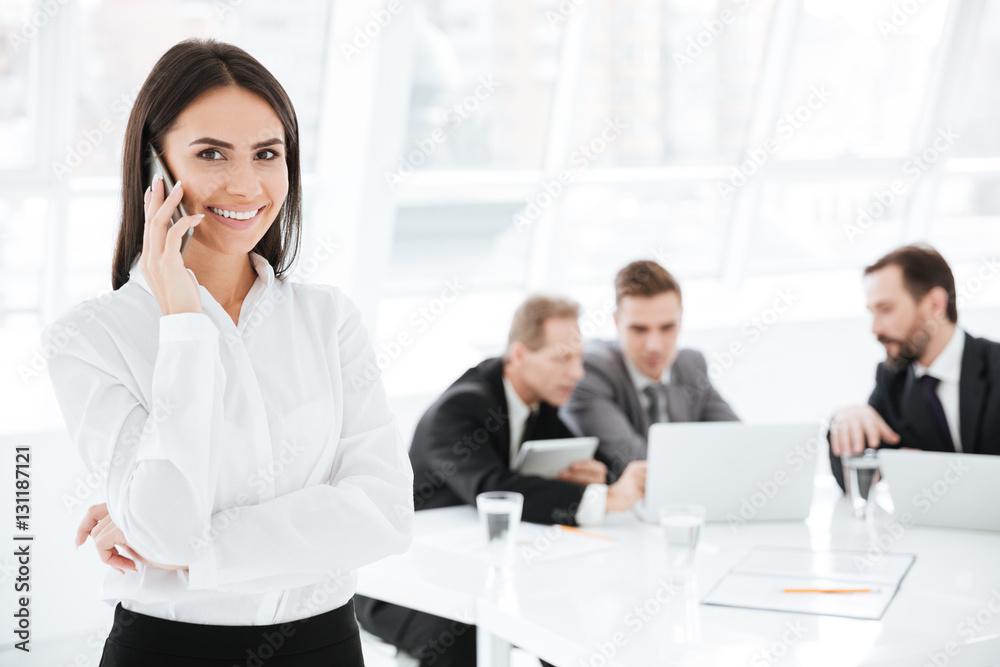 Attractive Business woman with colleagues on background Attractive Business woman with colleagues on background