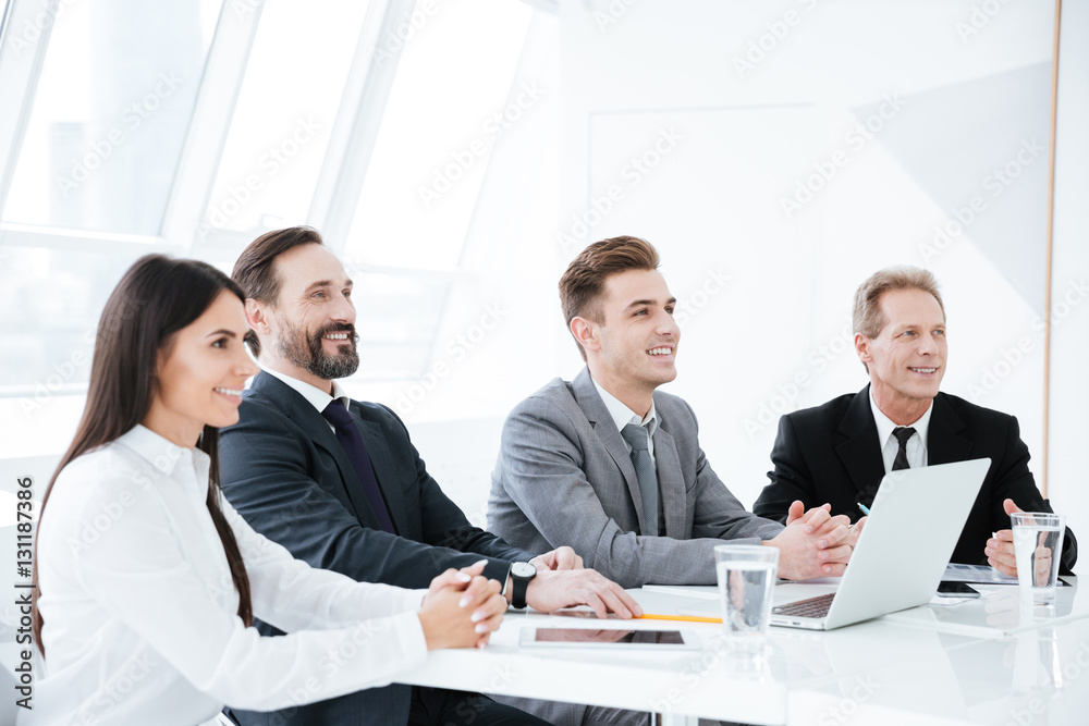 Side view of Business people by the table Side view of Business people by the table