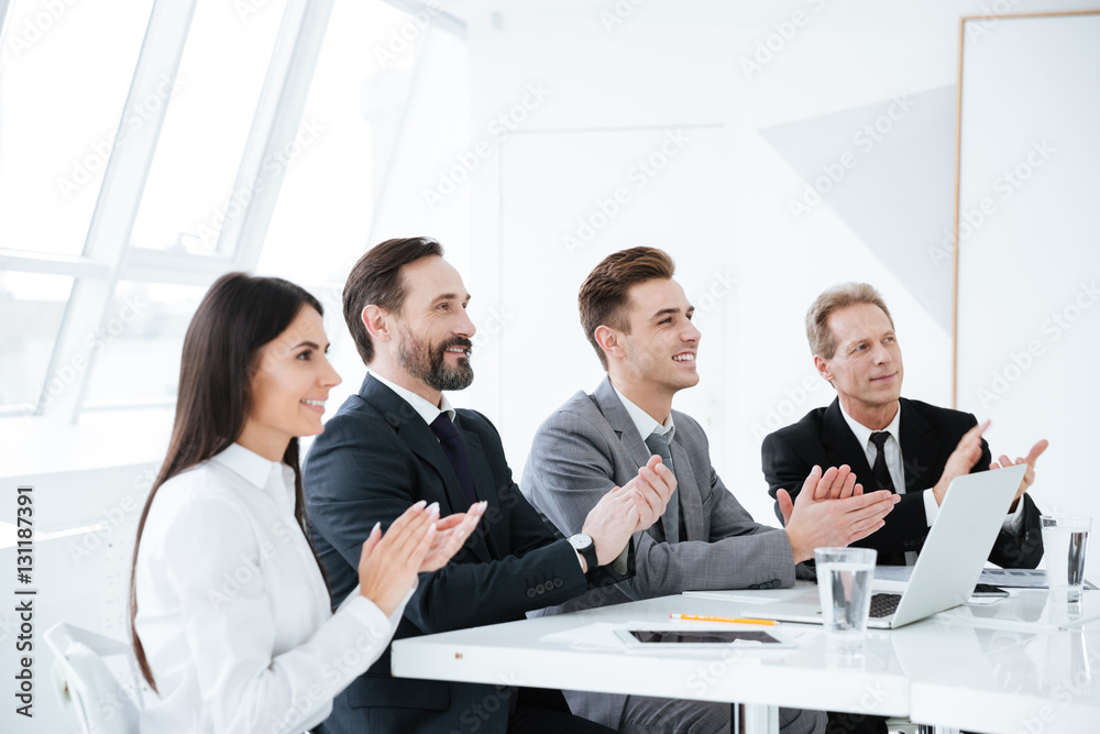 Side view of Smiling Business people by the table Side view of Smiling Business people by the table