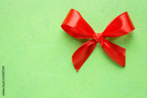 Red bow on green texture
