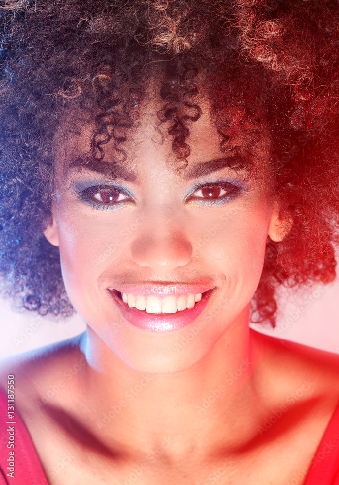 Smiling girl with afro.