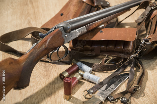 double-barreled shotgun, bullets, knife and cartridge belt