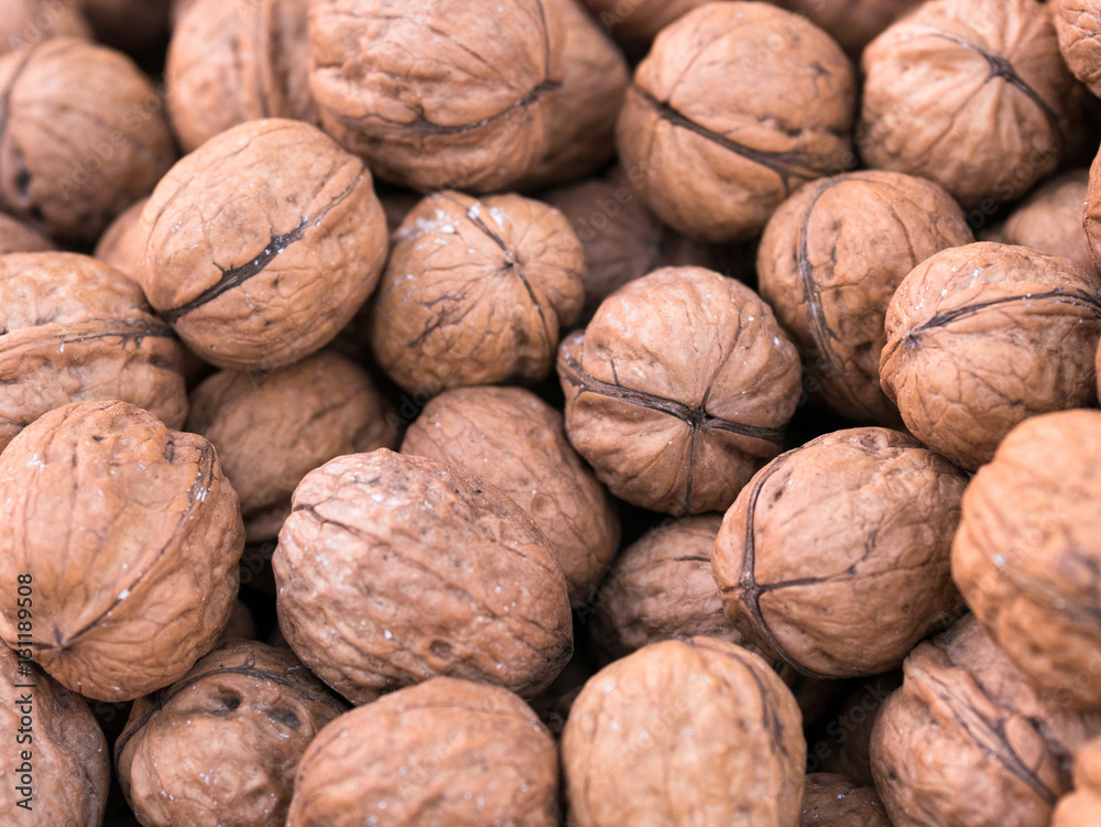 Scattered pile of fresh walnut in market Scattered pile of fresh walnut in market