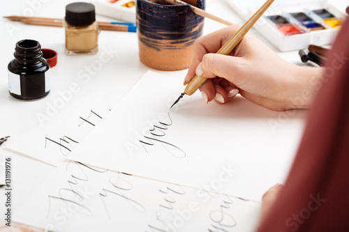 Girl writing calligraphy on postcards. Art design. photo