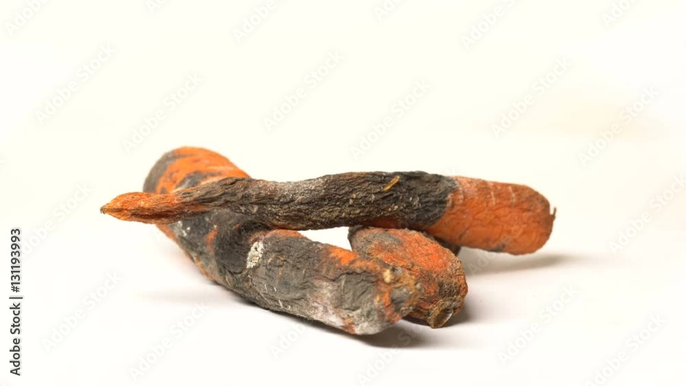 Spoiled rotten carrots rotates on a white table Spoiled rotten carrots rotates on a white table