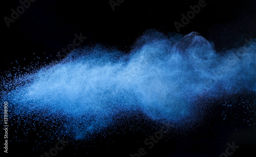 Blue powder cosmetics against black background photo