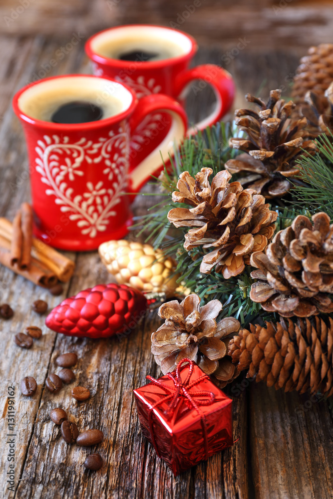 Two cup of coffee, pine cones and New-Year tree decorations Two cup of coffee, pine cones and New-Year tree decorations