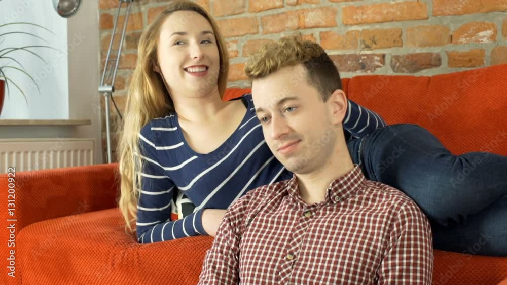 Happy couple chatting with each other in the living room, steadycam shot
Happy couple chatting with each other in the living room, steadycam shot