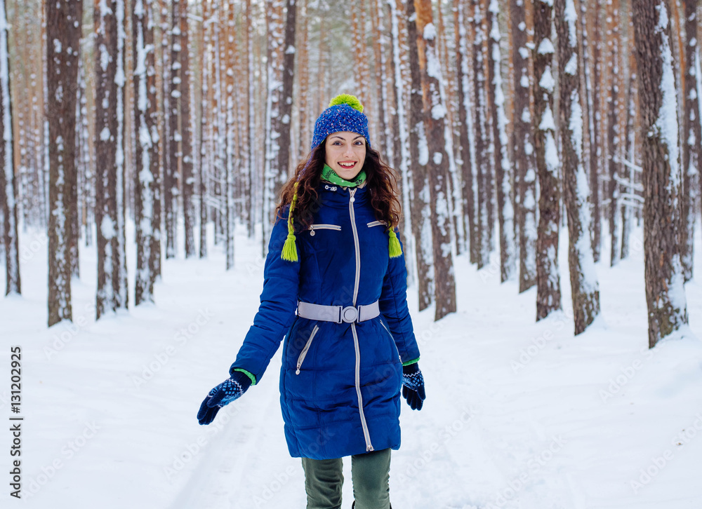 young female enjoying winter in snowy park young female enjoying winter in snowy park