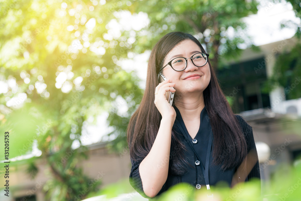 Portrait of a smiling beautiful asian woman talking with her pho